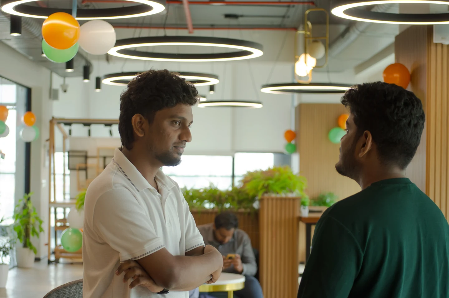 Two colleagues talking in a VGTS office common area