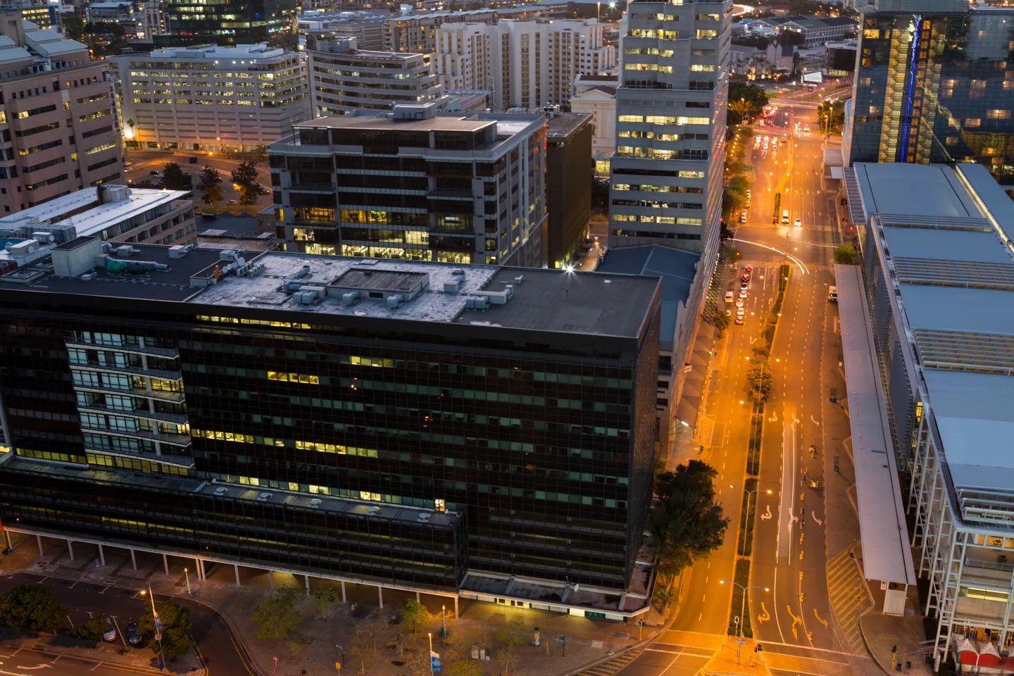 Stock photograph of office buildings and streets in a business district at dusk
